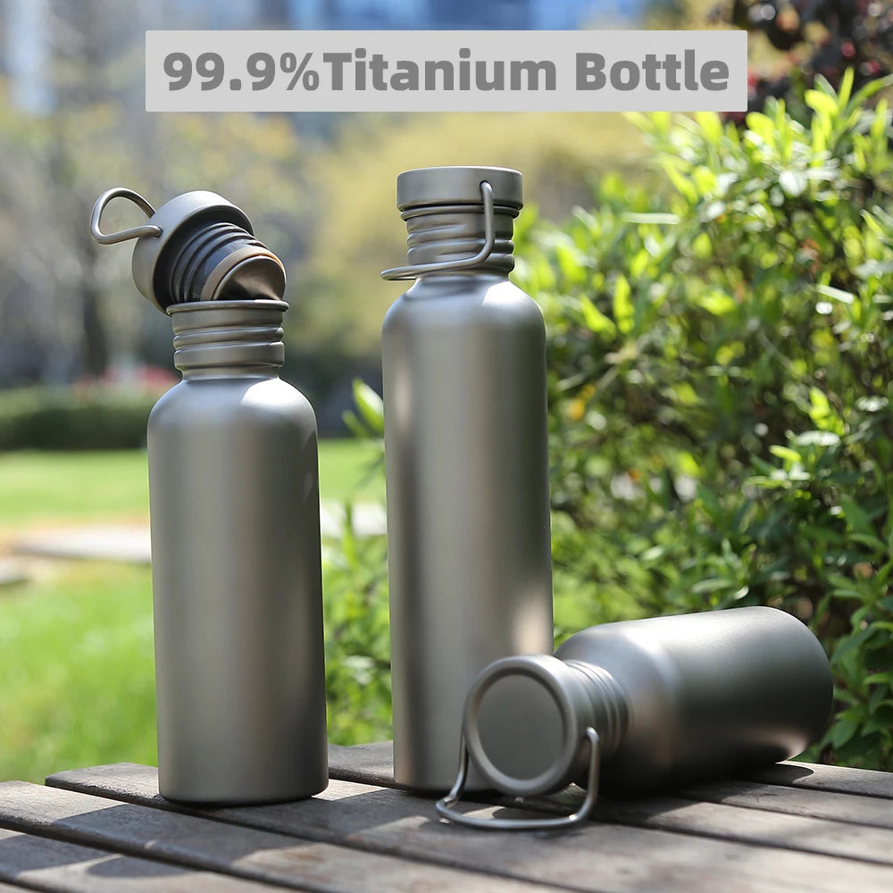 99.9% titanium thermos bottles for outdoor hydration on wooden table with greenery background